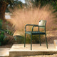 Fritz Hansen Vind Outdoor Dining Armchair in Hunter Green — lifestyle view
