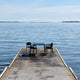 Fritz Hansen Vind Table with Armchair in Hunter Green — lifestyle setting side view