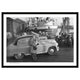 Innes Heritage Donald Innes At Work 1950 A2 Framed Art Print in Black frame Standard Vanguard car with man on car phone and holding a vintage camera on a dockside in hull with Teano Hull trawler and massey ferguson tractors on quayside waiting to be loaded up for export. historical image back from 1950