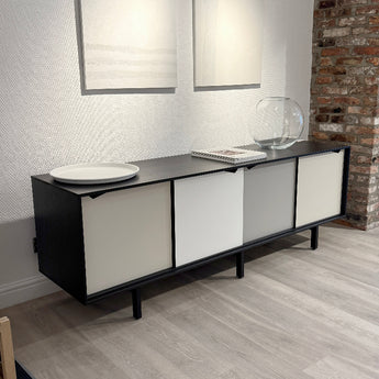 A black lacquered oak finish sideboard with multicoloured doors and drawers.