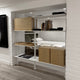 A contemporary Pira G2 floor-to-ceiling shelving unit with metallic frames and wooden shelves.