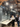 People in a modern office setting with wooden beams and industrial design elements. Hay Compass Pendant launch at 3DD 2025 Copenhagen