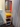 Montana KIMPOP. Small colorful cabinet with a mirror above it next to a white curtain.