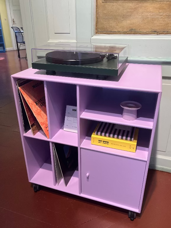 Montana Spin. Purple entertainment console with a turntable and records in a room.