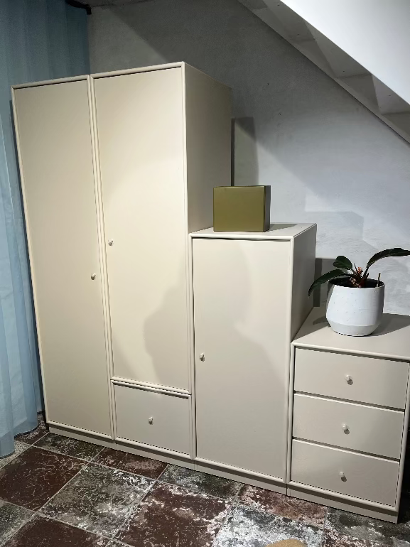 Montana Beige wardrobe and dresser with a plant on a tiled floor.