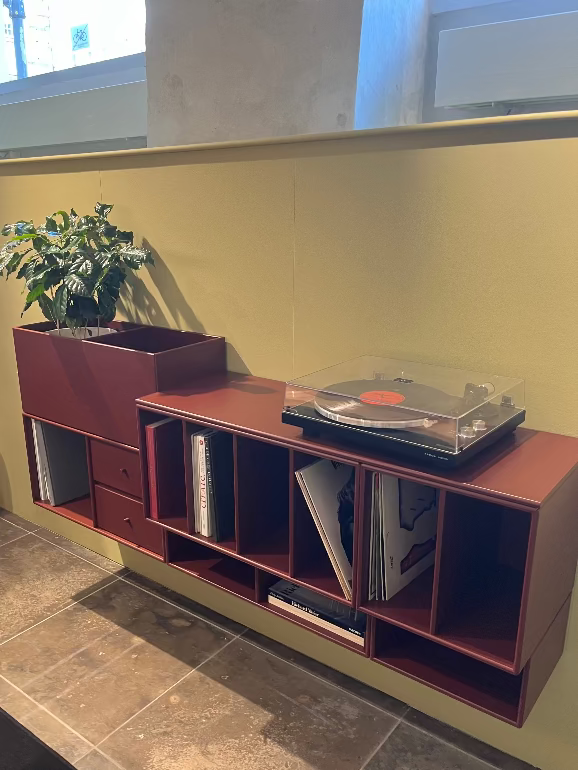 Montana system modern storage for Record player  with shelves against a wall.