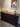 Montana modern storage dresser with a plant and small table in a room with a framed picture on the wall.