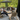 Carl Hansen outdoor furniture with People sitting on outdoor furniture with a green wall in the background