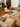 Living room with wooden chairs, glass coffee table, and people in the background. Carl Hansen Copenhagen showroom 3DD 2025. Hans Wegner furniture.