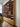 Large wooden bookshelf in a room with a person looking at it.Carl Hansen Copenhagen showroom 3DD 2025. Ole Wanscher shelving