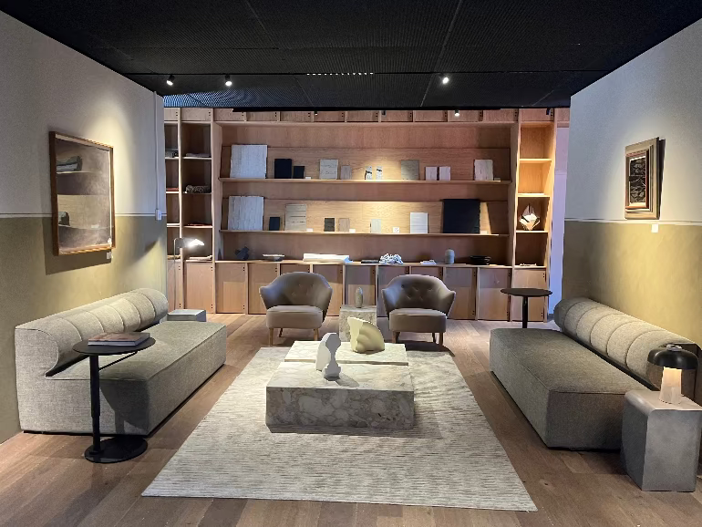 Modern living room with Scandi greige sofas, coffee table, and bookshelves at the Audo Copenhagen Hotel in Denmark.