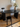 Modern Eclipse black desk / dressing table with a stool and vase of flowers in a room. Audo Copenhagen hotel