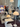 Display of modern lamps at a showroom with people observing. Louis Poulsen Copenhagen showroom during 2025 3 Days of Design