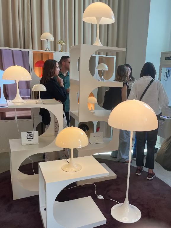Display of modern Louis Poulsen verner panton lanthella lamps at a showroom with people observing at 3DD 2025