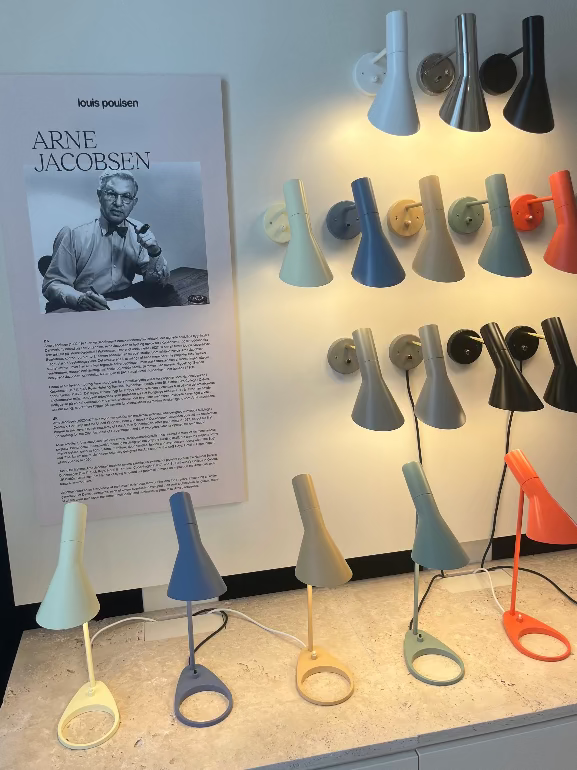 Display of Arne Jacobsen lamps with a poster on a wall at Louis Pouslen showroom in Copenhagen at 3DD 2025