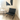 Black leather chair in a room with a abstract painting on the wall. Knoll Barcelona Chair Bauhaus 100th Anniversary Limited Edition Black
