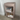 Montana Carry storage wheeled unit. Small beige shelf with books and boxes against a white wall.