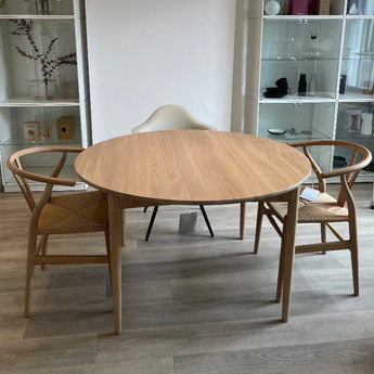 Carl Hansen BM0121 round solid, white pigmented oak scandi dining table with ch24 wishbone dining chairs on display in Innes showroom in Hessle, East yorks, UK