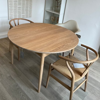 Carl Hansen BM0121 round solid, white pigmented oak scandi dining table with ch24 wishbone dining chairs on display in Innes showroom in Hessle, East yorks, UK