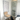 Vitra Design Museaum Chair Collection large framed wall print next to Knoll Cesca counter stool and Montana glass fronted storage unit