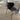 Back of Fritz Hansen 3107 Series 7 Dining chair, front upholstered in black essential leather and black ash frame and black lacquered legs in Innes showroom on oak floor