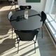 Fritz Hansen Arne Jacobsen designed modern scandi style small black dining table and chair set in Innes showroom in Hessle, East Yorkshire with Ikebana vase.