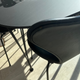 close up of back of black leather upholstered fritz hansen 3107 dining chair