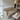 Audo Offset 2 seater sofa in Boucle 02 - A modern beige fabric sofa in a contemporary living room setting, positioned next to a marble-top coffee table with a lit candle, with a large abstract art print on the wall behind it at Innes showroom in Hessle, UK