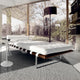 Knoll Barcelona Reax Day bed and saarinen side table in modern living room with large glass windows