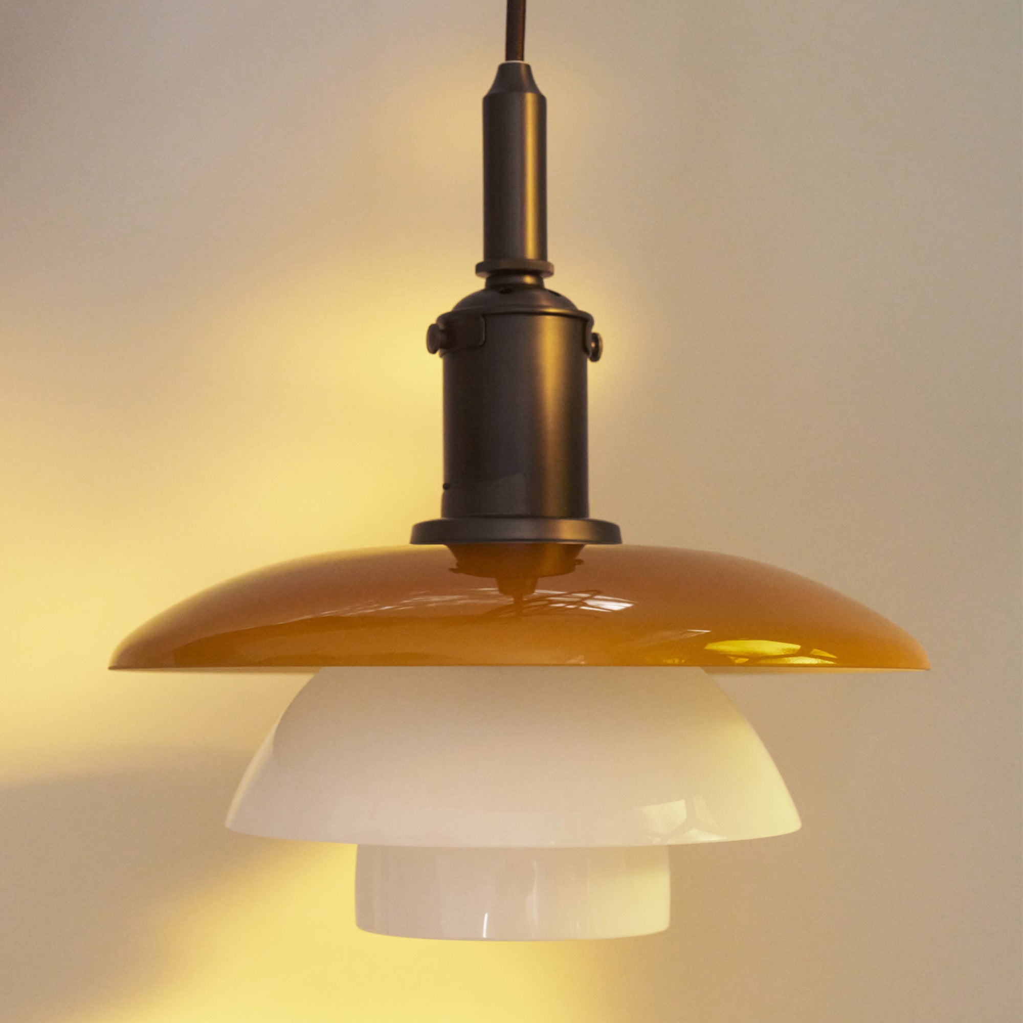 Louis Poulsen PH 3/3 Pendant Light Centenary Edition in aged brass with amber and white opal glass - lifestyle, detail
