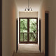 Louis Poulsen PH 1/1 Chandelier Centenary Edition 3-arm in a hallway setting