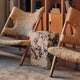 Audo Knitting Lounge Chair Sheepskin — lifestyle, with Plinth, Duca Candle Holder and Houkime Rug
