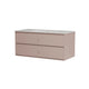 A modern two-drawer vanity cabinet in a muted dusty pink finish, featuring a light speckled sink top and a single round drawer pull, shown against a plain white background.