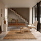 Carl Hansen OW149 Colonial Chair in Oak Soap — lifestyle, with OW149F Footstool, OW150 Colonial Sofa and OW449 Coffee Table. Modern scandi dining room with wooden furniture, rugs and concrete floors and microplaster