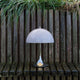 Louis Poulsen Panthella 250 Portable The Originals — Original Blue Grey illuminated in an outdoor setting