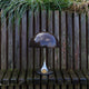 Louis Poulsen Panthella 250 Portable The Originals — Original Brown illuminated in an outdoor setting