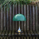 Louis Poulsen Panthella 250 Portable The Originals — Original Green illuminated in an outdoor setting