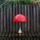  Louis Poulsen Panthella 250 Portable The Originals — Original Opal Red illuminated in an outdoor setting
