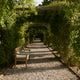 Skagerak Drachmann Outdoor Bench 200 — lifestyle, with Bench Cushion in Light Apricot/Dark Green Stripe, detail