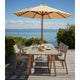 Skagerak Messina Parasol in Golden Yellow Stripe — lifestyle, with Skagerak Ballare Outdoor Dining Chair and Ballare Outdoor Dining Table