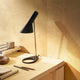 Louis Poulsen AJ Mini Table Lamp Black Brass lifestyle office setting