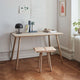 Skagerak Georg Oak Desk in Untreated Oak — lifestyle, with Georg Low Stool