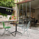 Vitra Belleville Bistro Table Outdoor Round in Deep Black — lifestyle, outdoor terrace, with Vitra Eames Plastic Side Chair DSR and Wire Chair DKR