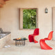 Vitra Panton Dining Chair in Classic Red — lifestyle, covered terrace with Flower Table