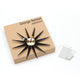 Vitra Sunburst Wall Clock in Black and Brass with presentation box — packshot