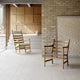 Carl Hansen CH45 Rocking Chair in Oak Oil — lifestyle, with CH44 lounge chair and cushion