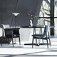 Carl Hansen E020 Embrace Dining Table in Oak Black — lifestyle, with E005 Embrace Dining Armchair and E004 Embrace Dining Chair