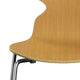 A Fritz Hansen 3101 Ant Dining Chair with a wooden backrest and seat, four metal legs, in a wood finish. close up shot on white.