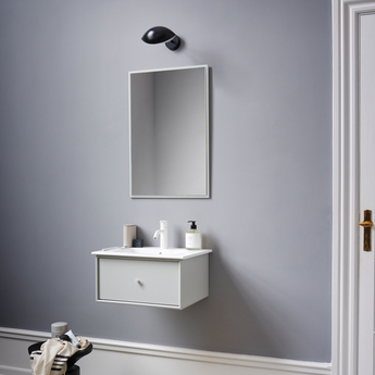 Bathroom with gray wall, white sink, and black and white checkered floor.